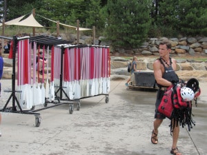 Action shot of a person walking with a life-jackets away from a cart.